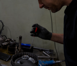 Technician using a hand tool on an automatic transmission clutch assembly